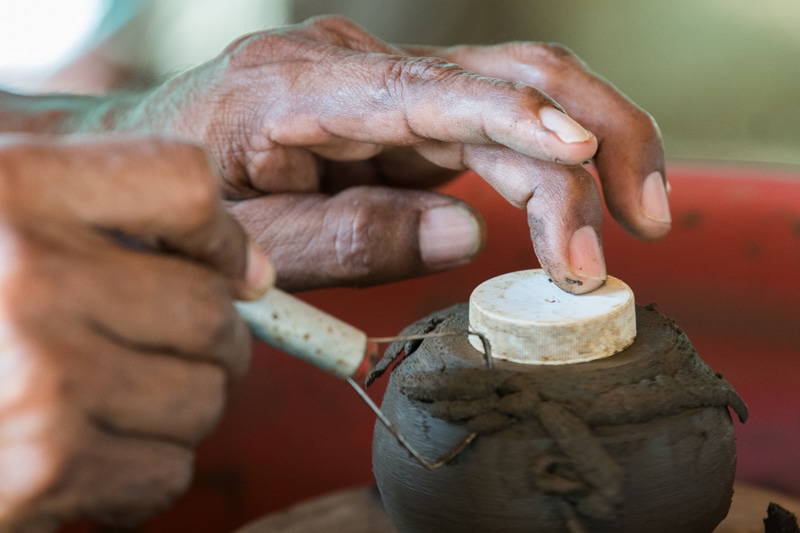 Ezequiel making pottery.