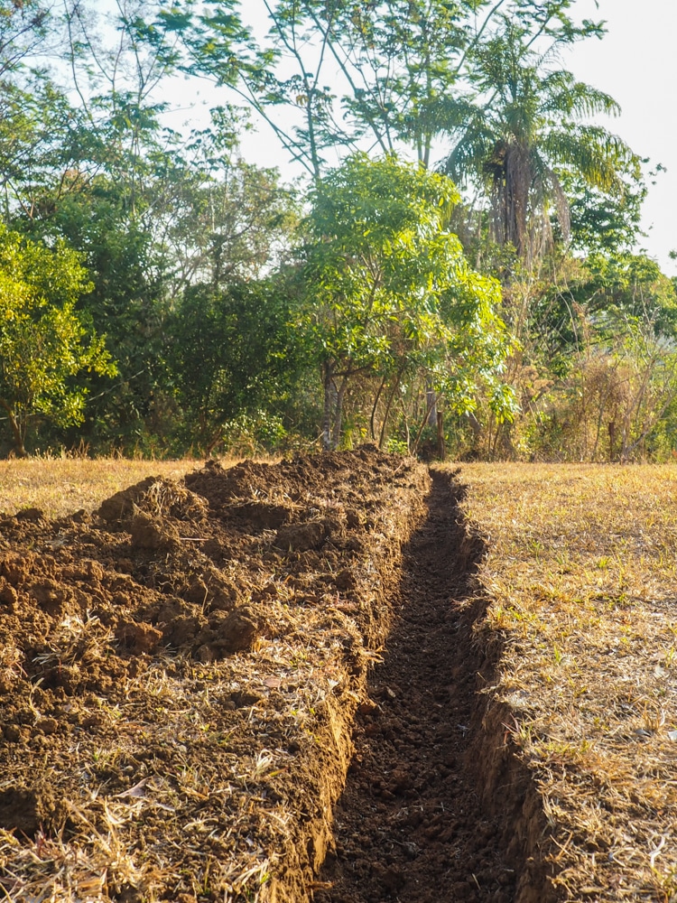 A trench dug by the volunteers to link water from Ezequiel's home to the cabin.