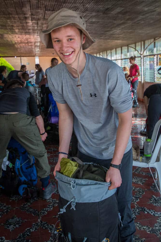 Volunteer packing his backpack before the trek.