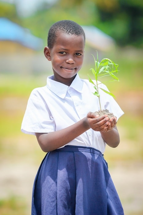One of the school children involved in the Raleigh Tanzania Society tree planting campaign