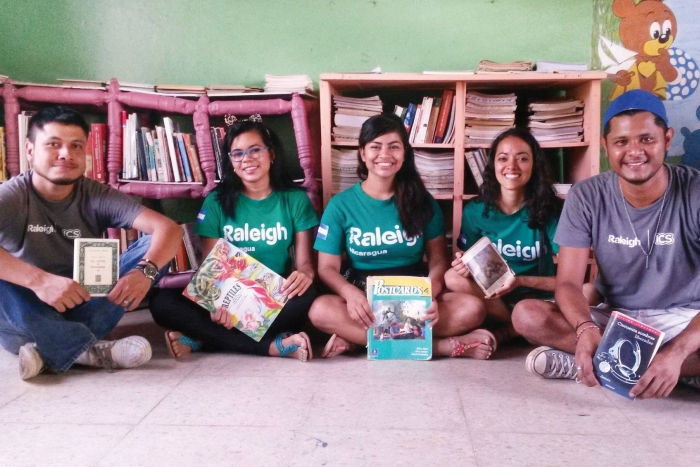 Alumni in Nicaragua sitting in the sustainable library they set up