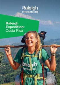 Volunteer in costa rica with a rucksackand holding a sticks with water