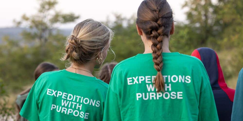 two volunteers with Raleigh Tshirt with the text Expedition with Purpose