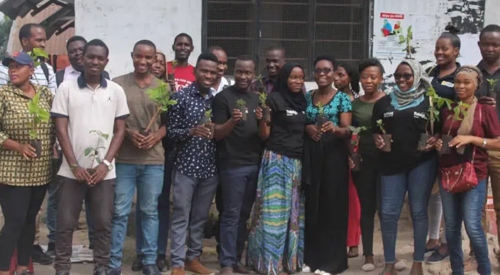 locals and volunteers having a group photo holding their plants