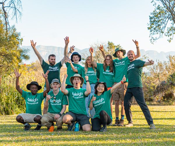 group of Raleigh volunteers happily posing for a photo