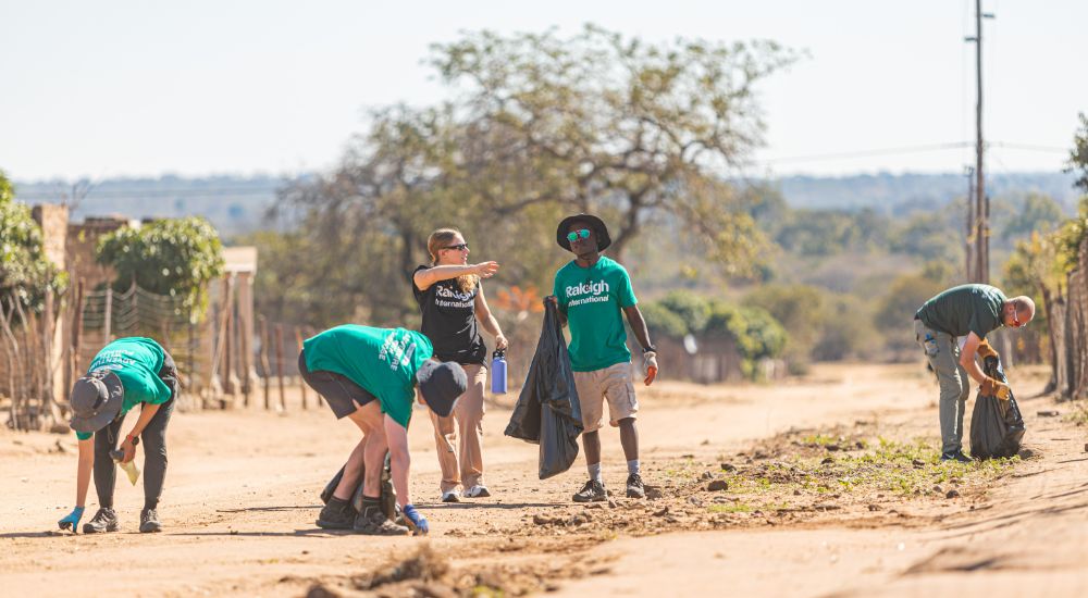 volunteers together picking trash