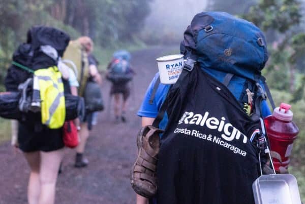 Raleigh volunteers trekking while carrying their bags