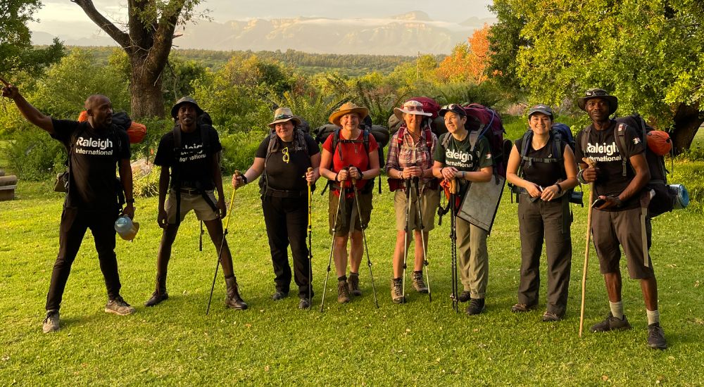 Raleigh Volunteers standing and holding trekking sticks.