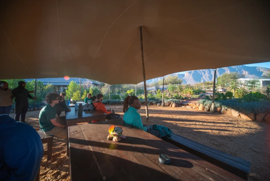 Raleigh South Africa_Group briefing under shade canopy with mountain view